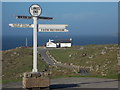 SW3425 : Land’s End: the signpost by Chris Downer