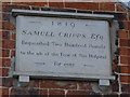 Sign above the almshouses opposite the church (c)