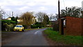 Bus shelter and yellow Rover/MG