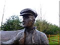H4474 : The farmer at the Spancelled sculpture, Mountjoy Forest East Division by Kenneth  Allen