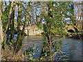 The arch of a bridge over a leat next to Great Bridge on the river Mole