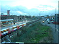 TQ3982 : Jubilee Line train passes Star Lane DLR station, light fading by Christopher Hilton