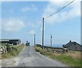 Farmhouse and farm buildings separated by the Head Road