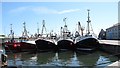 Five trawlers berthed side by side in Kilkeel Harbour