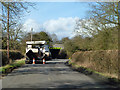 Road surfacing equipment parked near railway bridge