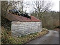 Wooden garage, with ant sculpture on the roof