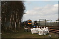 Departing train, birch trees and building materials