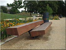 TQ3277 : Hardwood seat, western entrance, Burgess Park, Camberwell by Robin Stott