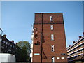 A collection of satellite dishes on the side of Keynsham House