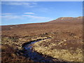 NH1988 : Peaty apron of Meall Dubh in Inverlael Forest by Ullapool by ian shiell