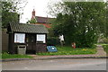 Bus shelter and notice board in Moortown