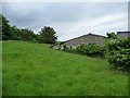 Land banked up behind agricultural buildings