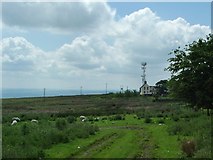 SO5975 : Titterstone Clee house and communications mast by Peter Evans