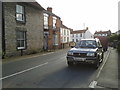 Car on the main road through Westonzoyland, between the church and the pub