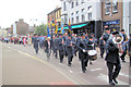 The Band leads the Procession down Tring High Street to the Memorial Garden