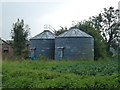TF2433 : Old grain silos at Eaudike Farm by Richard Humphrey