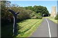 NZ2989 : NCN signpost and windmill by DS Pugh