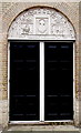 Tympanum sculpture on a former woollen cloth factory in Devizes