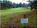 Footpath on golf course with warning sign