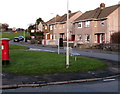 Postbox and bench on a corner in Bryntirion