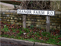 TL2454 : Manor Farm Road sign by Geographer