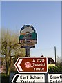 Pettaugh village sign almost lost among others