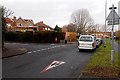 Red-edged triangle painted on the surface of Lyngford Road, Taunton