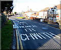 Bilingual message on the surface of Pillmawr Road, Malpas, Newport