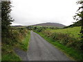 J0123 : Milltown Road with Slieve Gullion in the background by Eric Jones