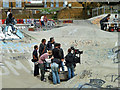 Film crew in skateboard park