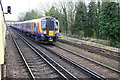 Charter train waits east of Staines Station for service trains to pass