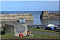 NU2519 : Craster Harbour and war memorial by Jim Barton