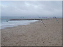 SZ0487 : Sandbanks: fishing rods on the beach by Chris Downer