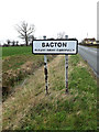 TM0565 : Bacton Village Name sign on the B1113 Finningham Road by Geographer