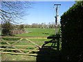 Gate into field with power lines