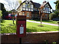 Postbox with house behind