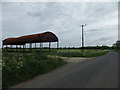 Fire damaged barn by roadside