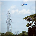 Helicopter hovering over electricity line