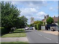 TL1049 : Church road and St Lawrence's church, Willington by Bikeboy