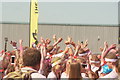 View of a sea of hands in the air at the Colour Run