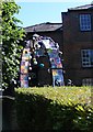 Archway at Tring parish church decorated with crocheted tea-pot coasters