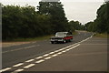 View of an American Ford Falcon passing along London Road as part of the London-Southend Classic Car Run