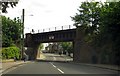 Teddington Road runs under a railway bridge