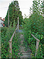 Footbridge and footpath sign, near Bapton, Boxted