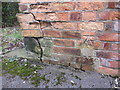 Weathered bench mark in Mountside, Scarborough