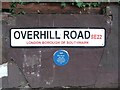 TQ3473 : Street nameplate and Blue Plaque, Overhill Road, East Dulwich by Chris Whippet
