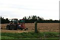 Turning the straw by the footpath off Greetwell Lane, Nettleham