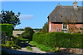 Track beside thatched cottage in Wootton Rivers