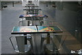 View of chairs and tables of Leon London reflected in the Blue Fin Building