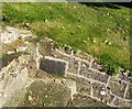 Llanstadwell Church - tiny gravestone built into side of steps by stile (J.E. + E.E.)